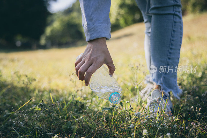 Woman hand holding garbage bottle plastic putting into recycle bag for cleaning